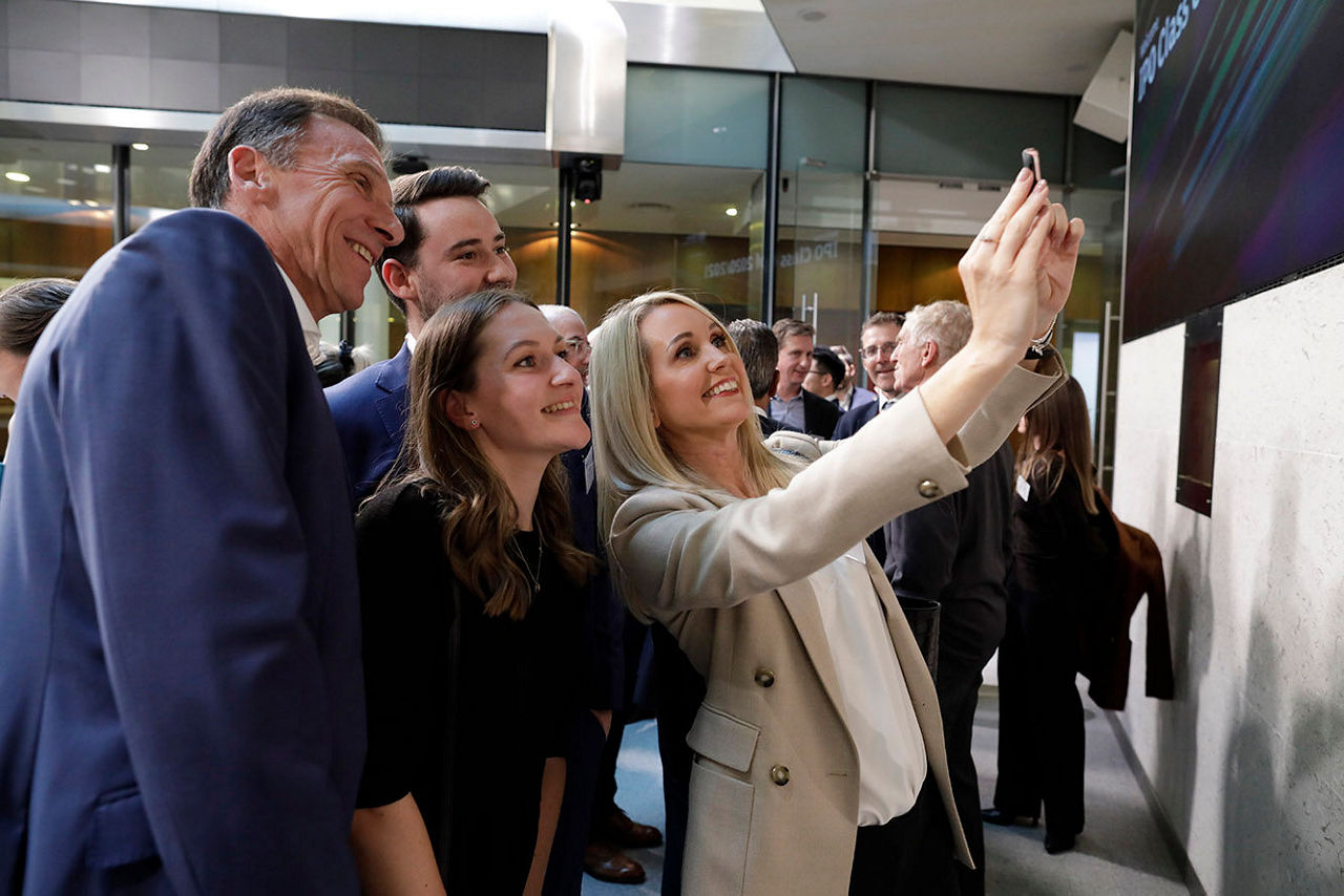 A group of people taking a selfie on the balcony at LSEG