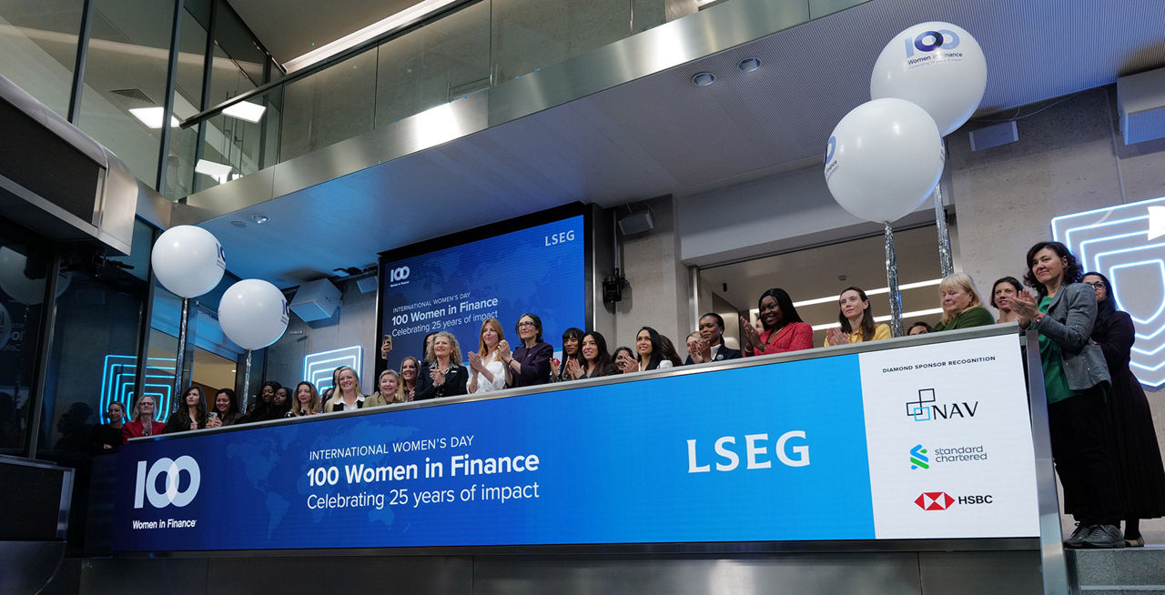 The team celebrating on the balcony at LSEG during the welcome ceremony.