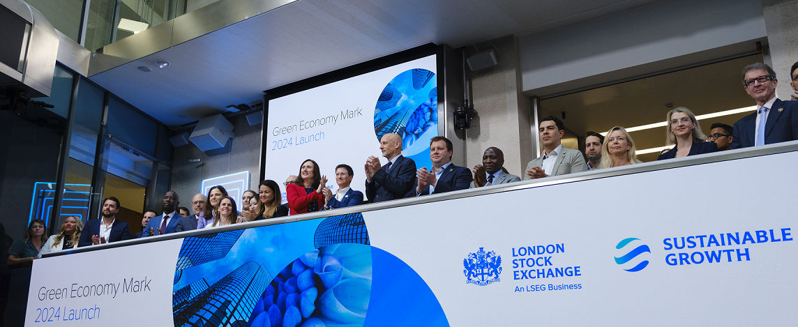 The team celebrating on the balcony at LSEG during the welcome ceremony.