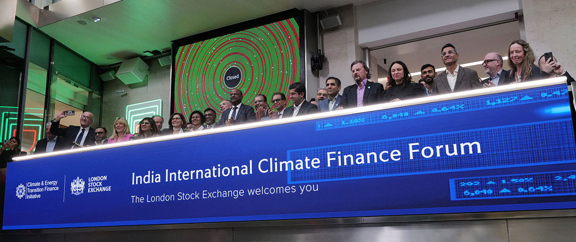 The team celebrating on the balcony at LSEG during the welcome ceremony.