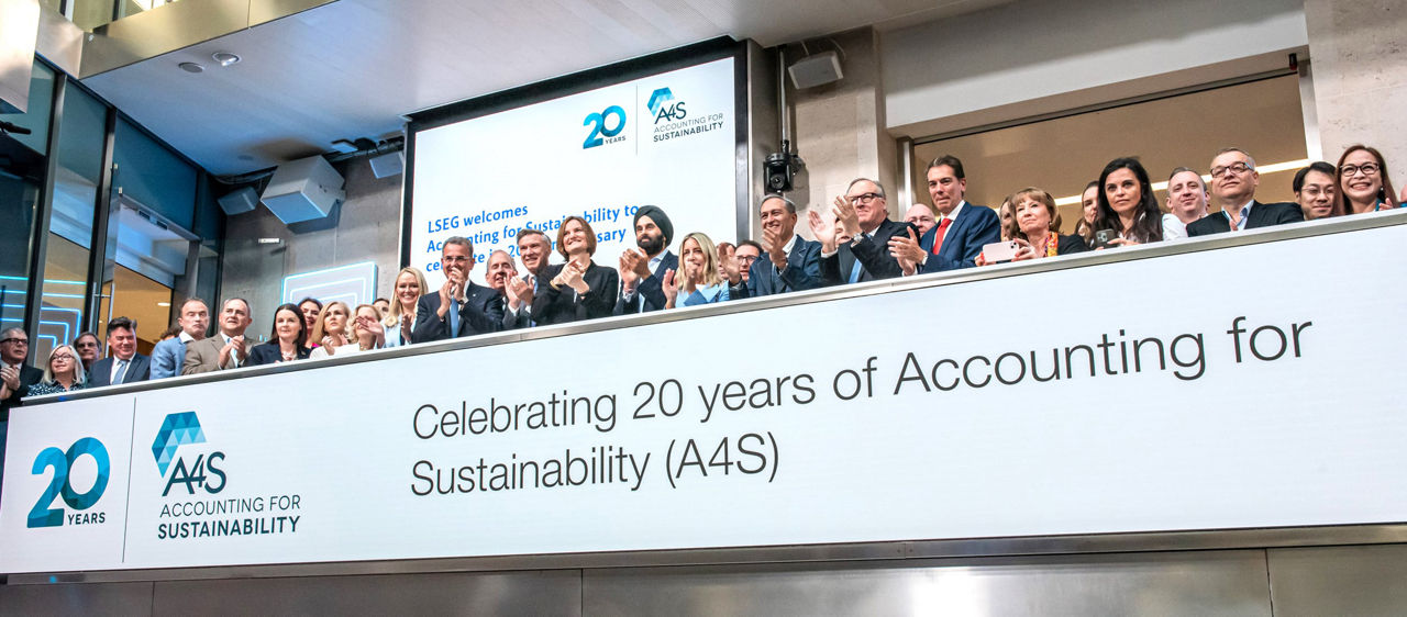 The team celebrating on the balcony at LSEG during the welcome ceremony.