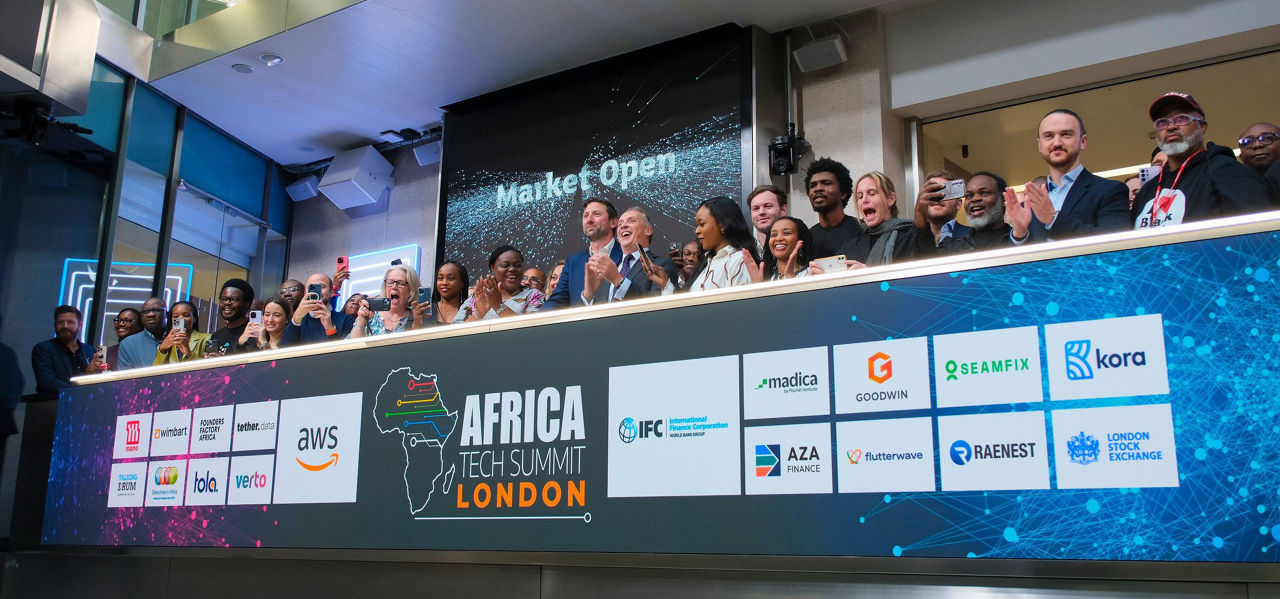 The team celebrating on the balcony at LSEG during the welcome ceremony.