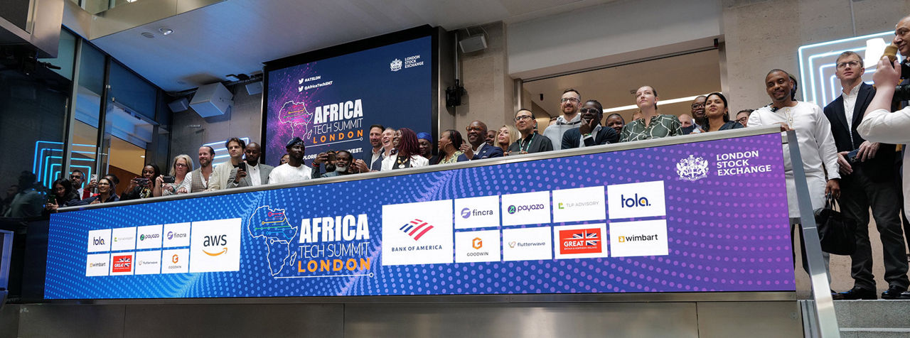 The team celebrating on the balcony at LSEG during the welcome ceremony.