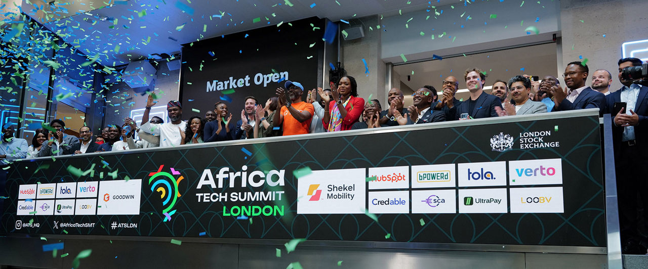 The team celebrating on the balcony at LSEG during the welcome ceremony.