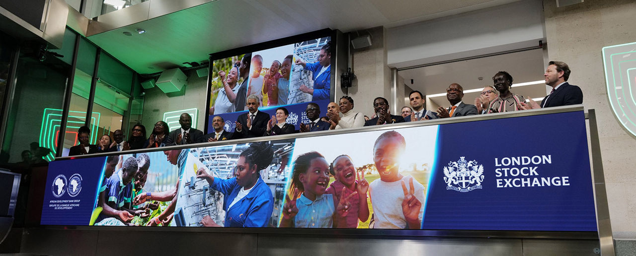 The team celebrating on the balcony at LSEG during the welcome ceremony.
