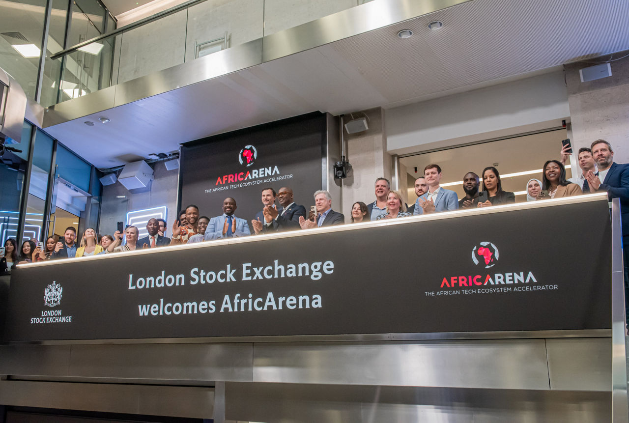 The team celebrating on the balcony at LSEG during the welcome ceremony.