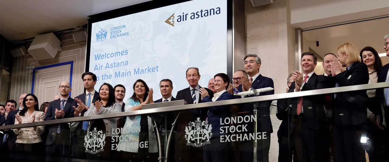 The team celebrating on the balcony at LSEG during the welcome ceremony.