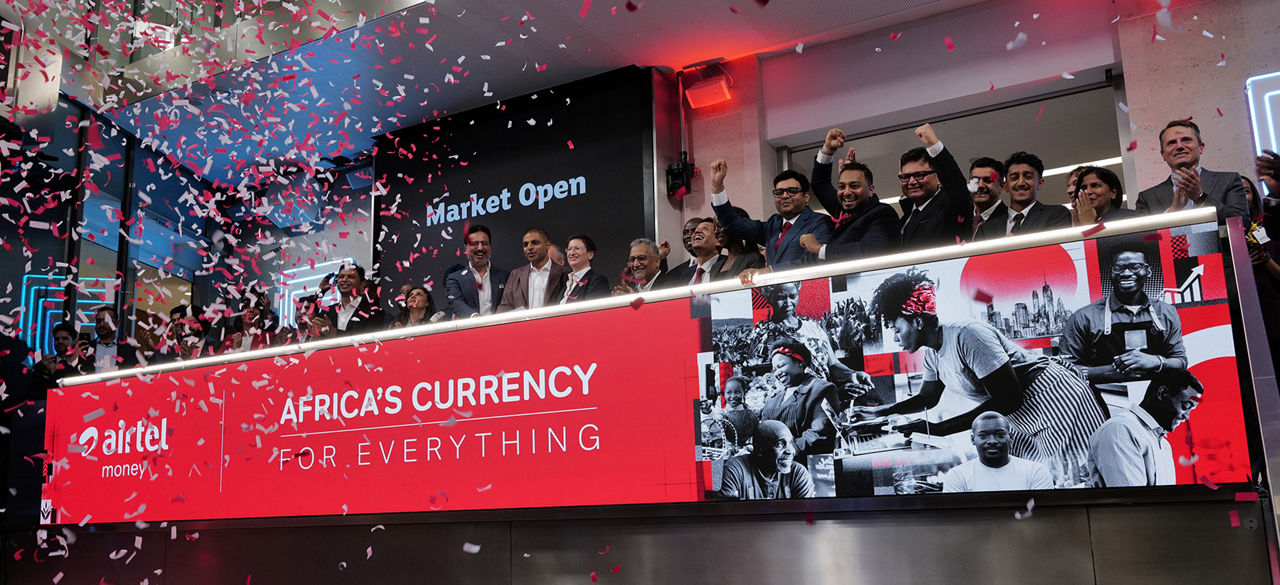 The team celebrating on the balcony at LSEG during the welcome ceremony.