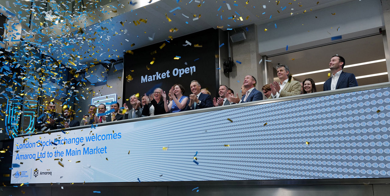 The team celebrating on the balcony at LSEG during the welcome ceremony.