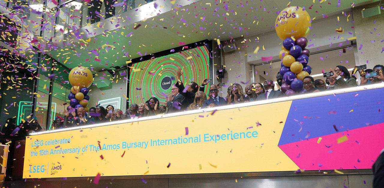 The team celebrating on the balcony at LSEG during the welcome ceremony.
