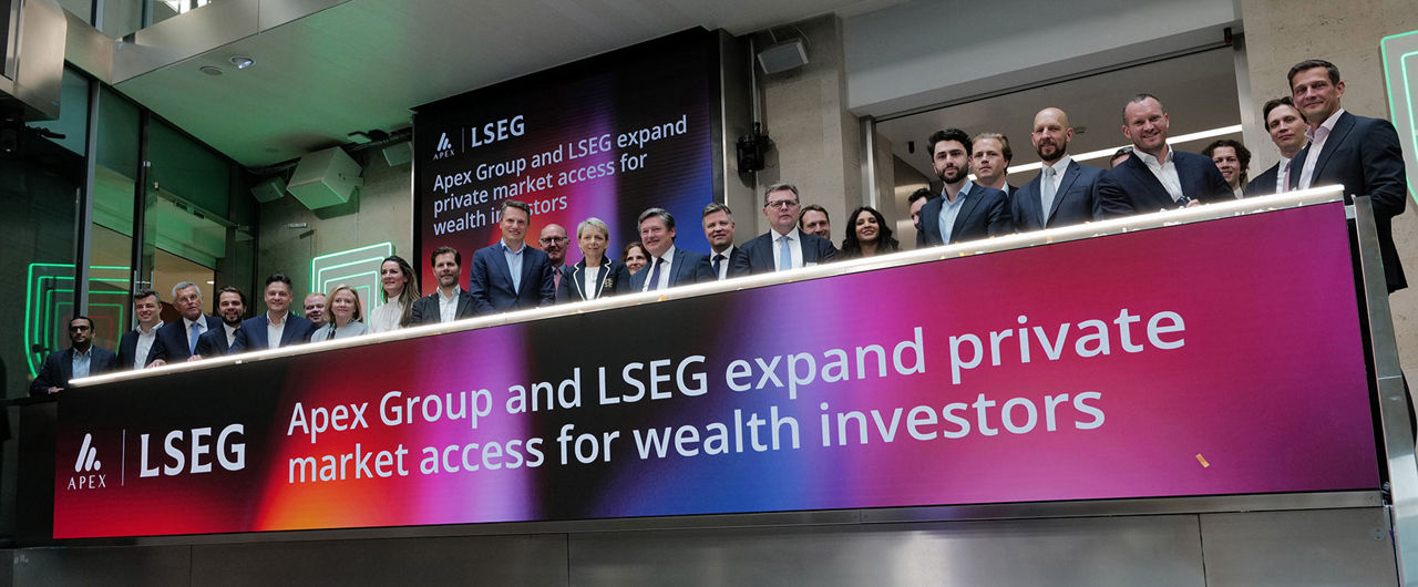 The team celebrating on the balcony at LSEG during the welcome ceremony.