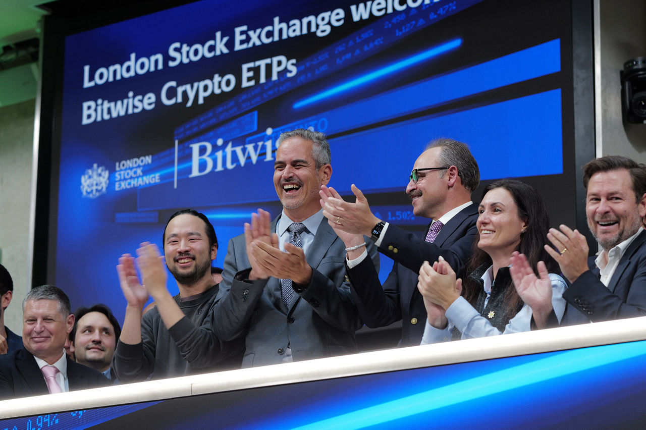 The team celebrating on the balcony at LSEG during the welcome ceremony.