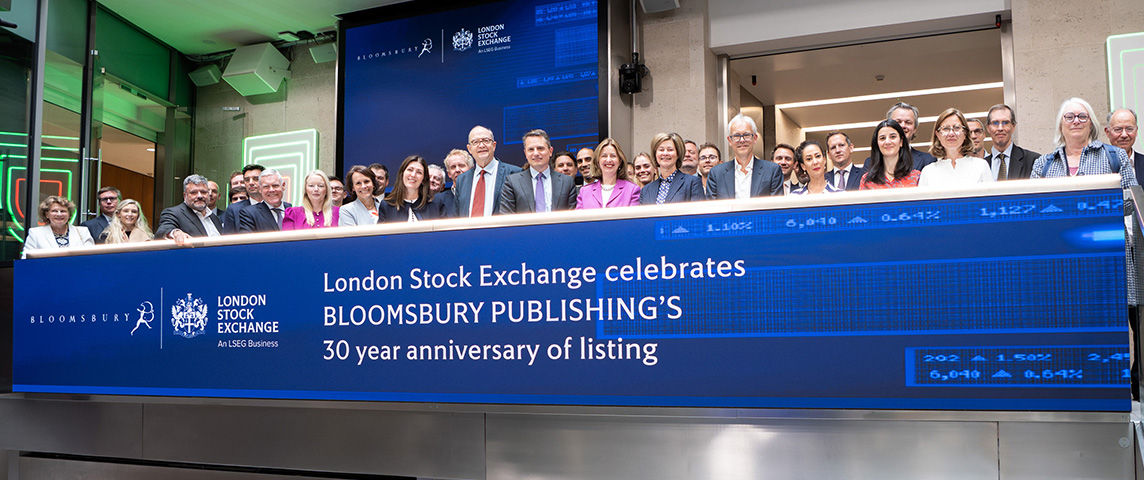 The team celebrating on the balcony at LSEG during the welcome ceremony.