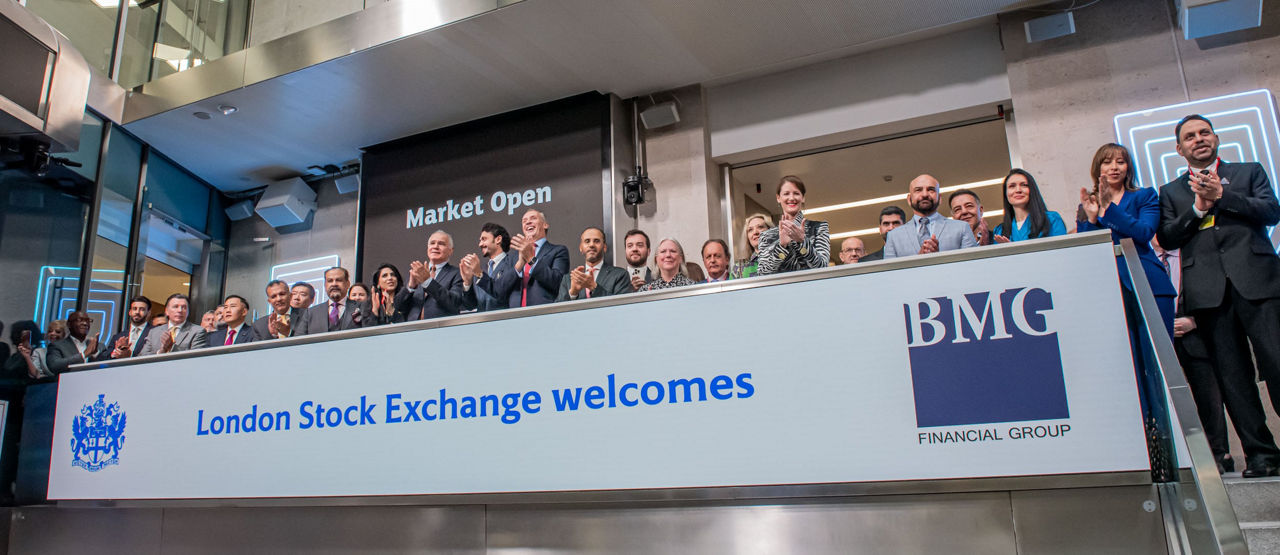 The team celebrating on the balcony at LSEG during the welcome ceremony.