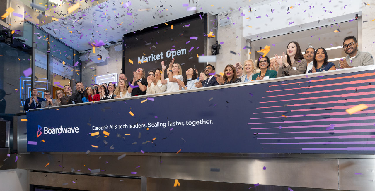 The team celebrating on the balcony at LSEG during the welcome ceremony.