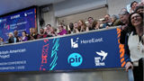 The team celebrating on the balcony at LSEG during the welcome ceremony.