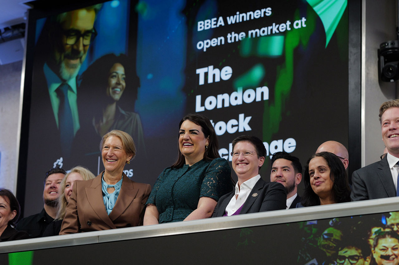 The team celebrating on the balcony at LSEG during the welcome ceremony.