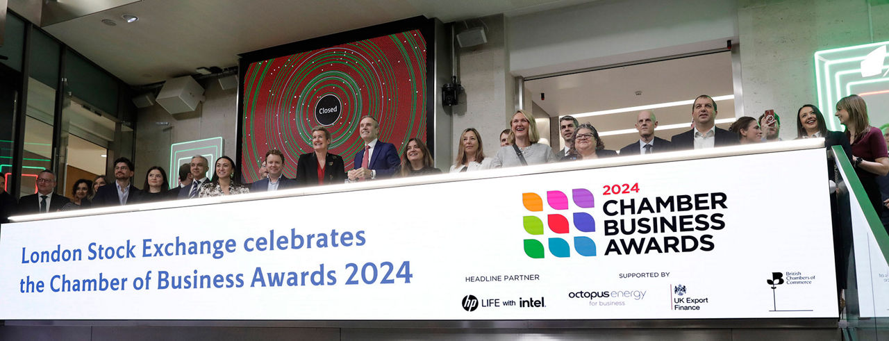 The team celebrating on the balcony at LSEG during the welcome ceremony.