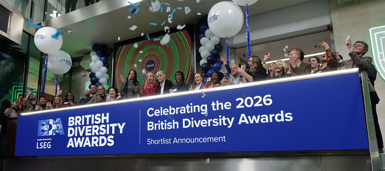 The team celebrating on the balcony at LSEG during the welcome ceremony.