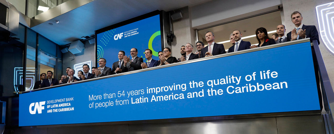 The team celebrating on the balcony at LSEG during the welcome ceremony.
