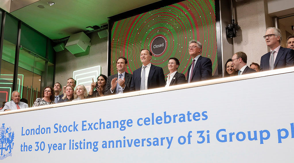 The team celebrating on the balcony at LSEG during the welcome ceremony.