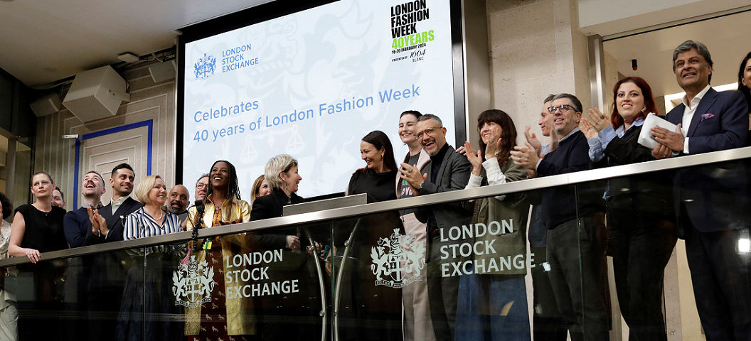 The team celebrating on the balcony at LSEG during the welcome ceremony.
