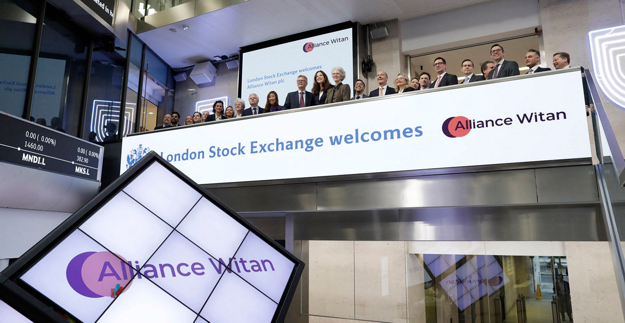 The team celebrating on the balcony at LSEG during the welcome ceremony.
