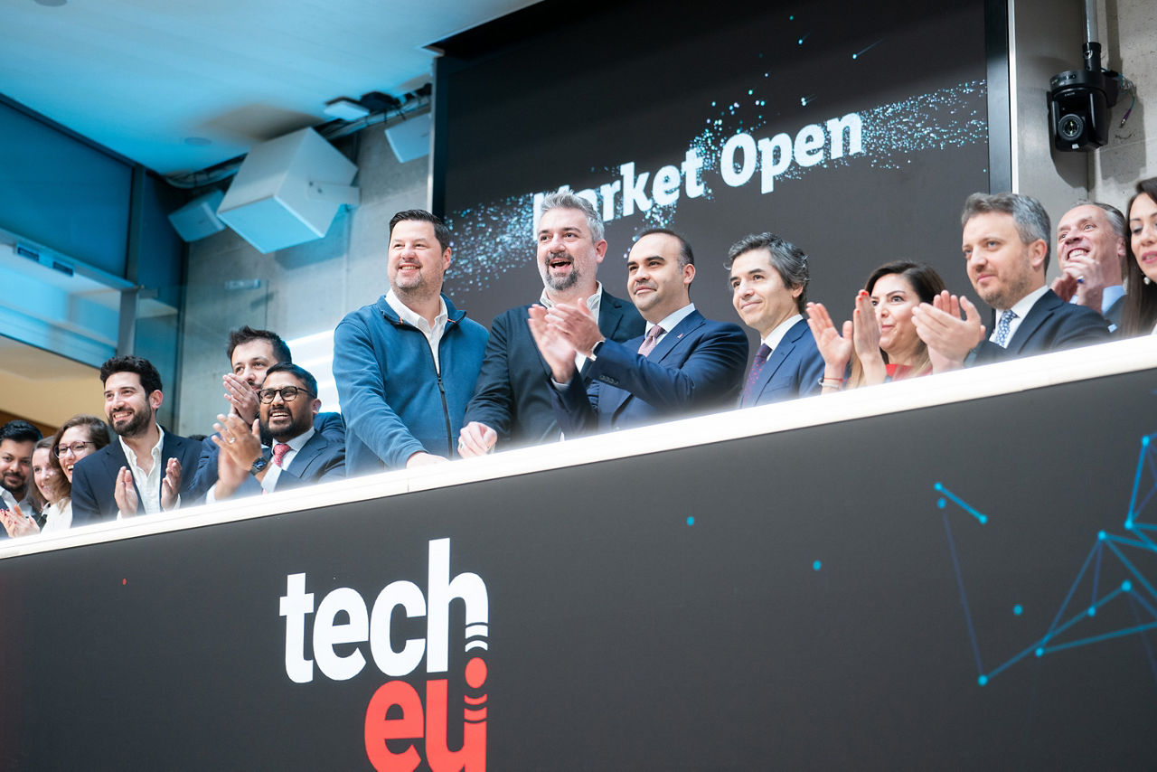 The team celebrating on the balcony at LSEG during the welcome ceremony.