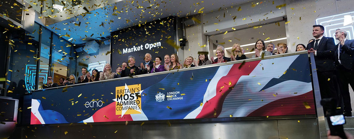 The team celebrating on the balcony at LSEG during the welcome ceremony.