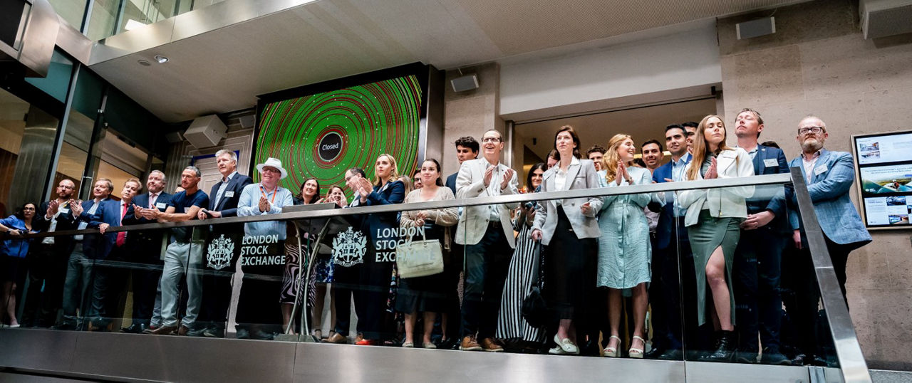 The team celebrating on the balcony at LSEG during the welcome ceremony.