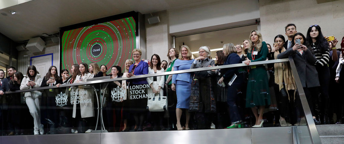 The team celebrating on the balcony at LSEG during the welcome ceremony.