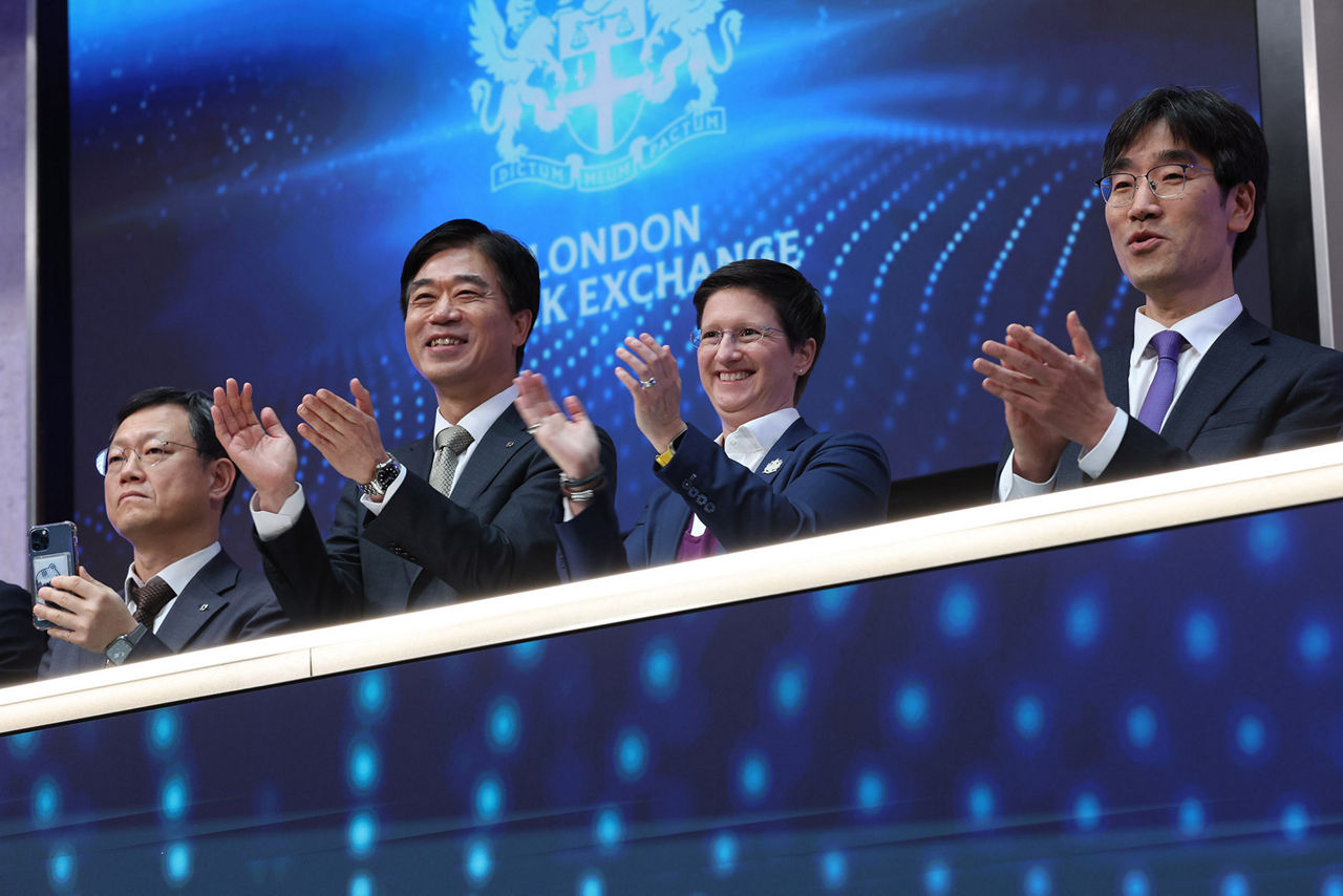 The team celebrating on the balcony at LSEG during the welcome ceremony.