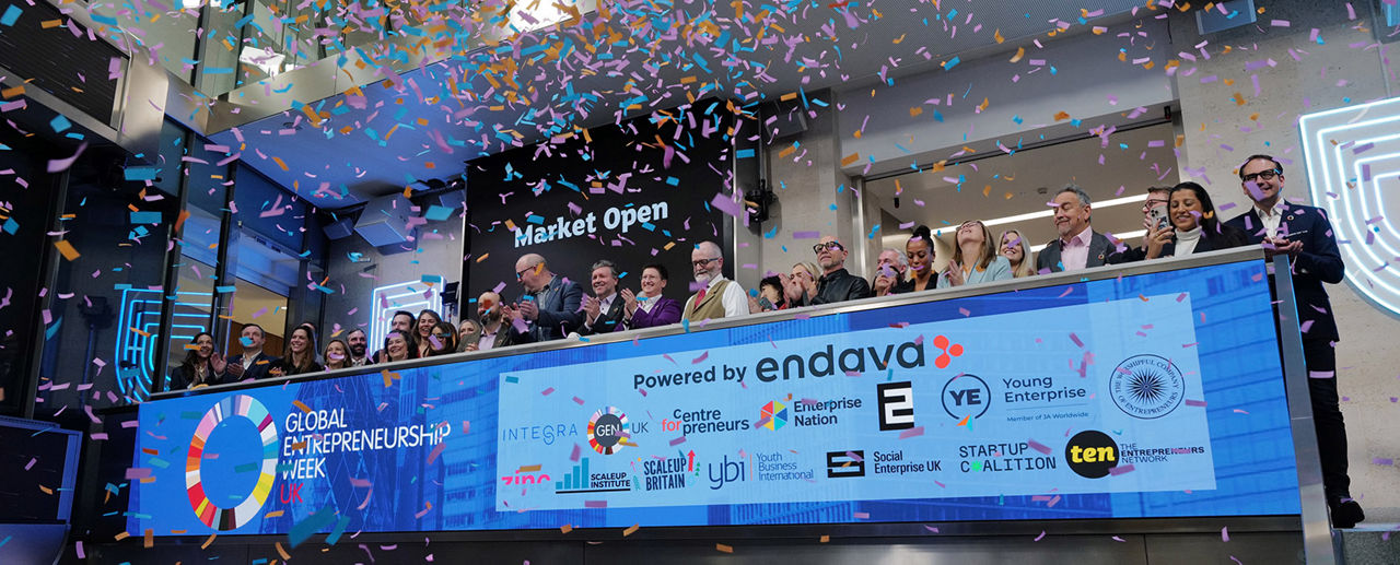 The team celebrating on the balcony at LSEG during the welcome ceremony.