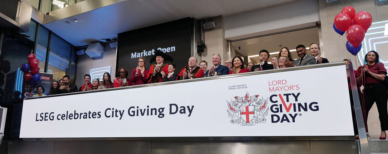 The team celebrating on the balcony at LSEG during the welcome ceremony.