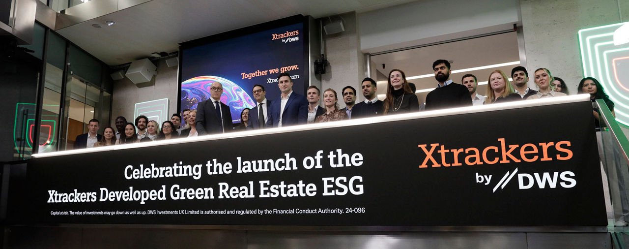 The team celebrating on the balcony at LSEG during the welcome ceremony.