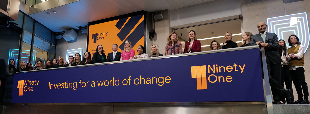The team celebrating on the balcony at LSEG during the welcome ceremony.
