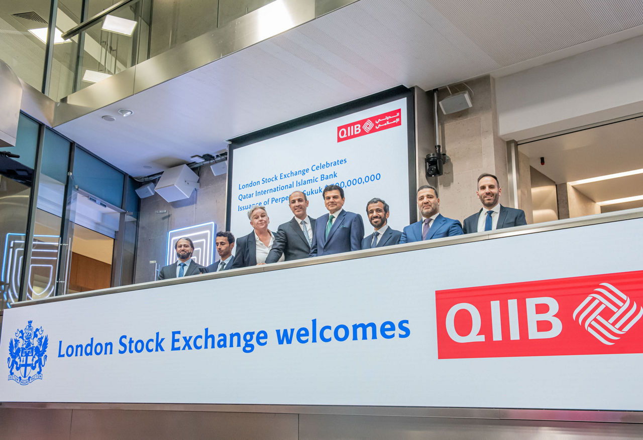 The team celebrating on the balcony at LSEG during the welcome ceremony.
