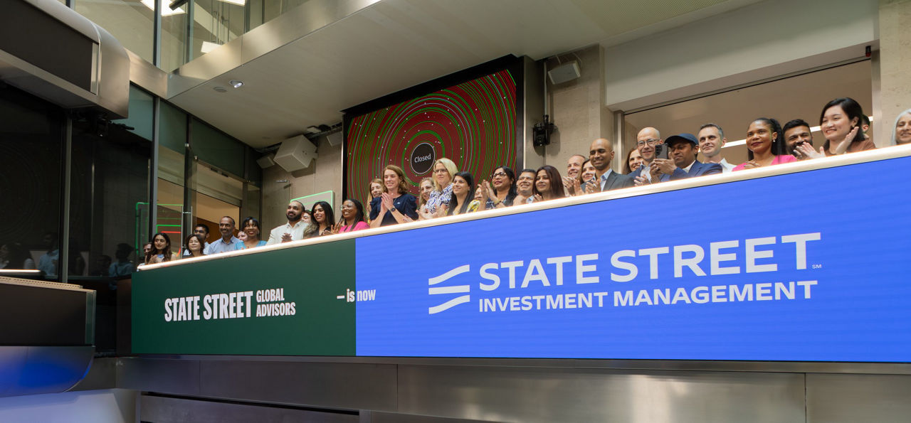 The team celebrating on the balcony at LSEG during the welcome ceremony.