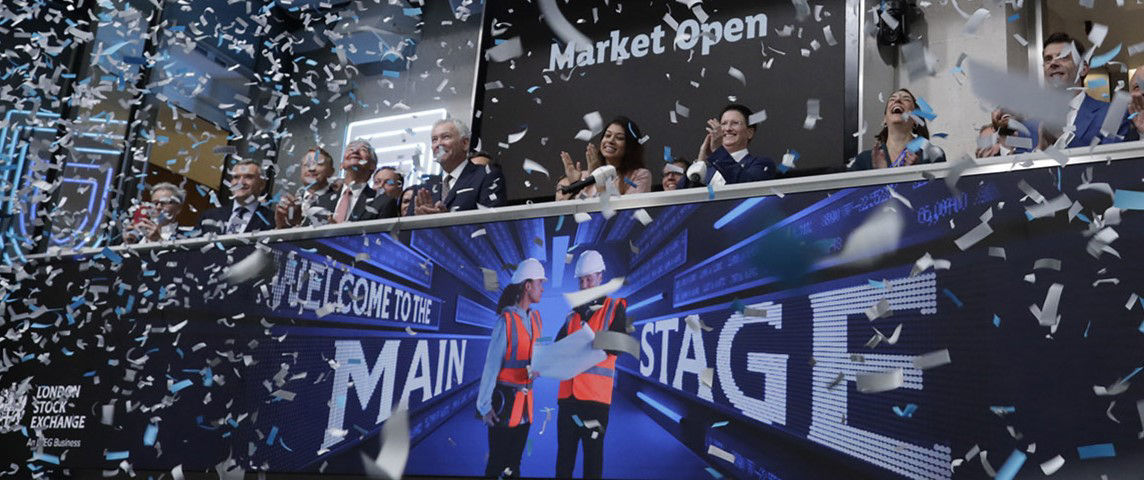 The team celebrating on the balcony at LSEG during the welcome ceremony.