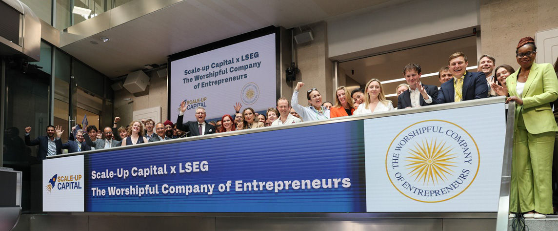 The team celebrating on the balcony at LSEG during the welcome ceremony.