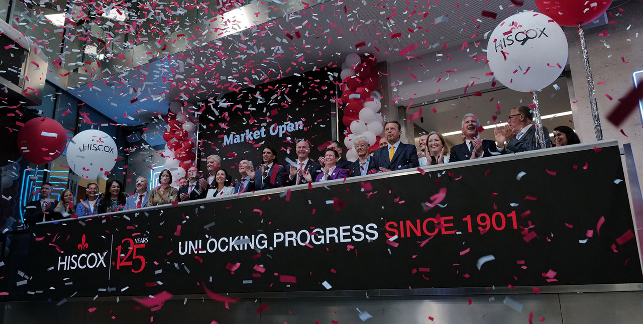 The team celebrating on the balcony at LSEG during the welcome ceremony.