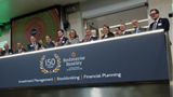 The team celebrating on the balcony at LSEG during the welcome ceremony.
