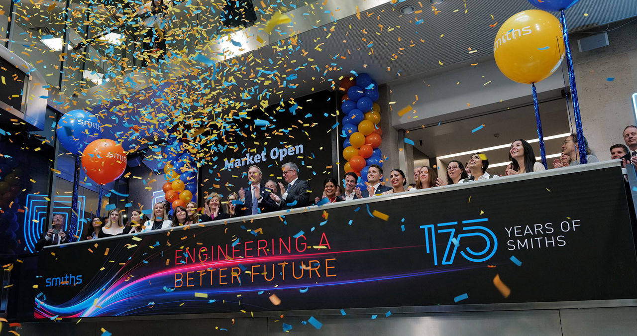 The team celebrating on the balcony at LSEG during the welcome ceremony.