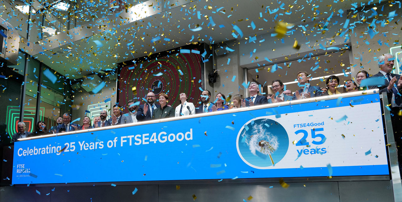 The team celebrating on the balcony at LSEG during the welcome ceremony.