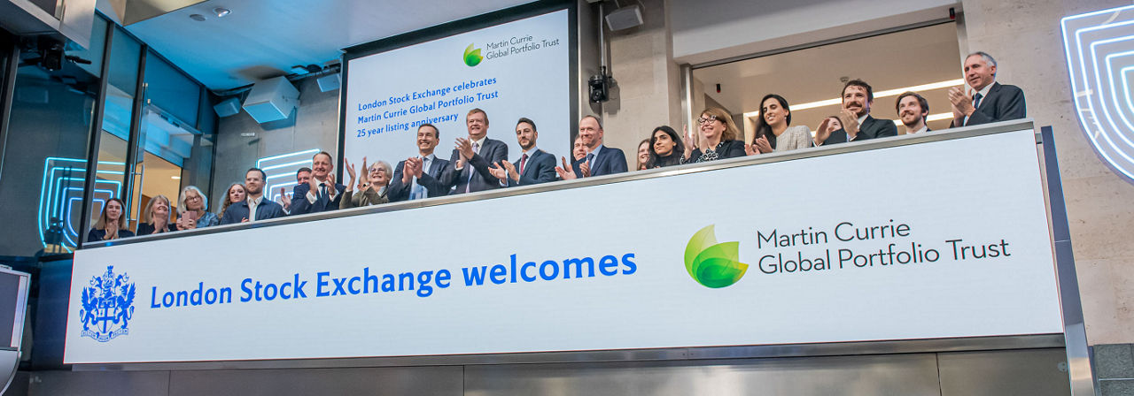 The team celebrating on the balcony at LSEG during the welcome ceremony