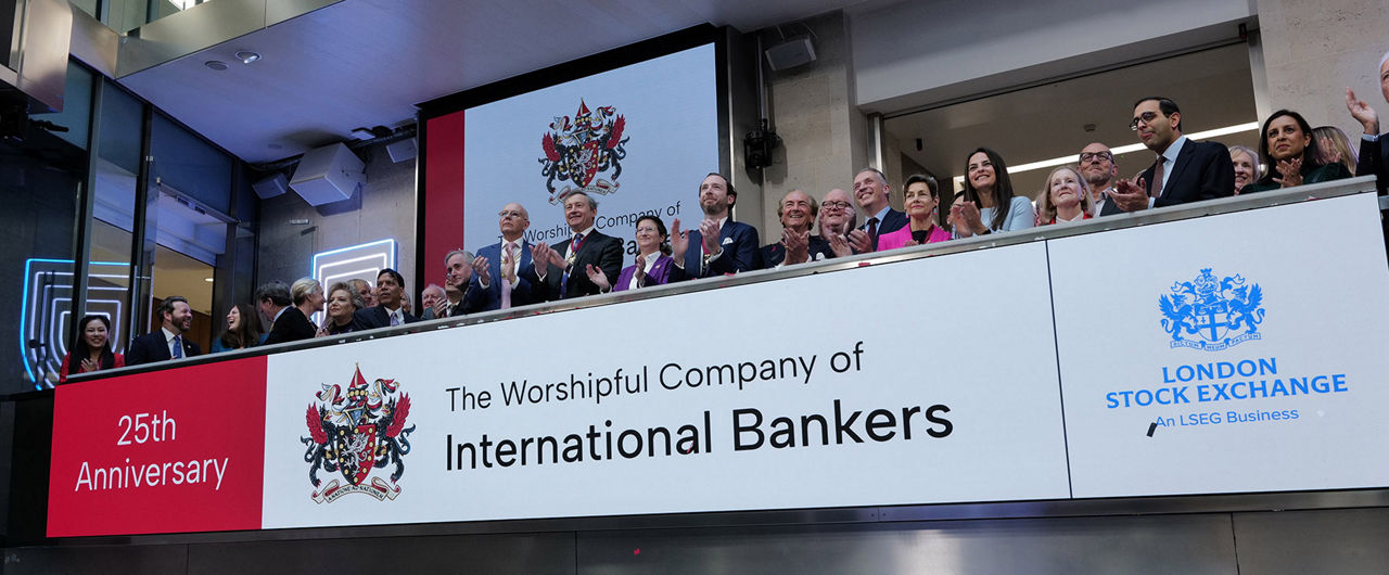 The team celebrating on the balcony at LSEG during the welcome ceremony.