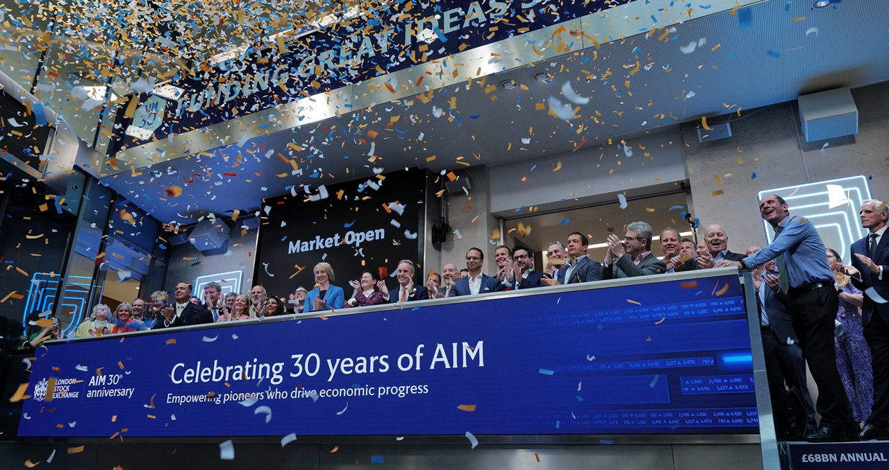 The team celebrating on the balcony at LSEG during the welcome ceremony.