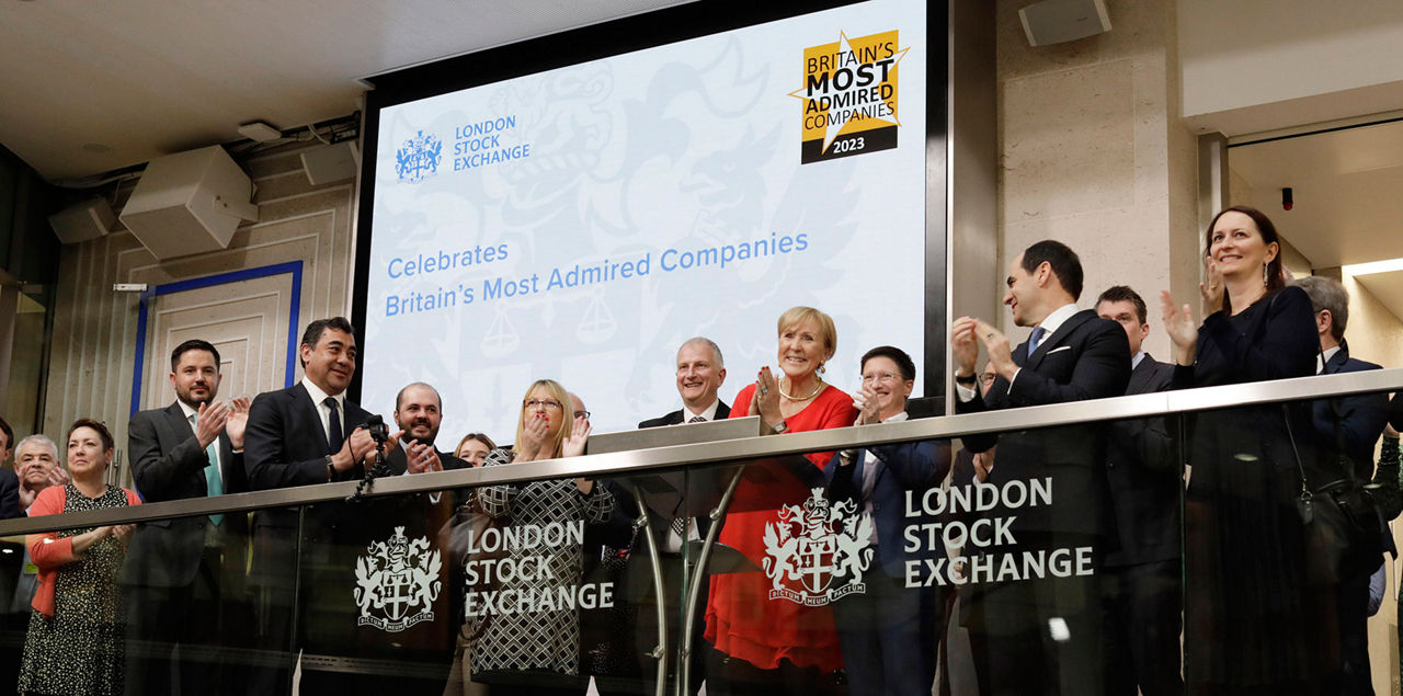 The team celebrating on the balcony at LSEG during the welcome ceremony.