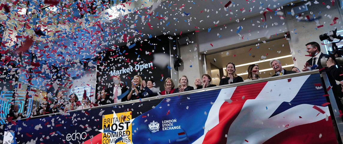 The team celebrating on the balcony at LSEG during the welcome ceremony.