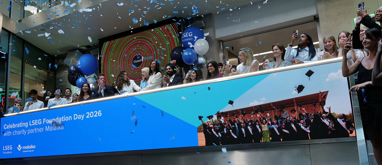 The team celebrating on the balcony at LSEG during the welcome ceremony.